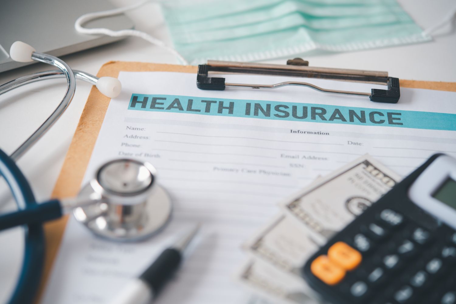 Health Insurance form with stethoscope and calculator